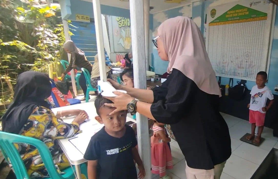 Pemeriksaan kembang tumbuh anak di Posyandu. 
